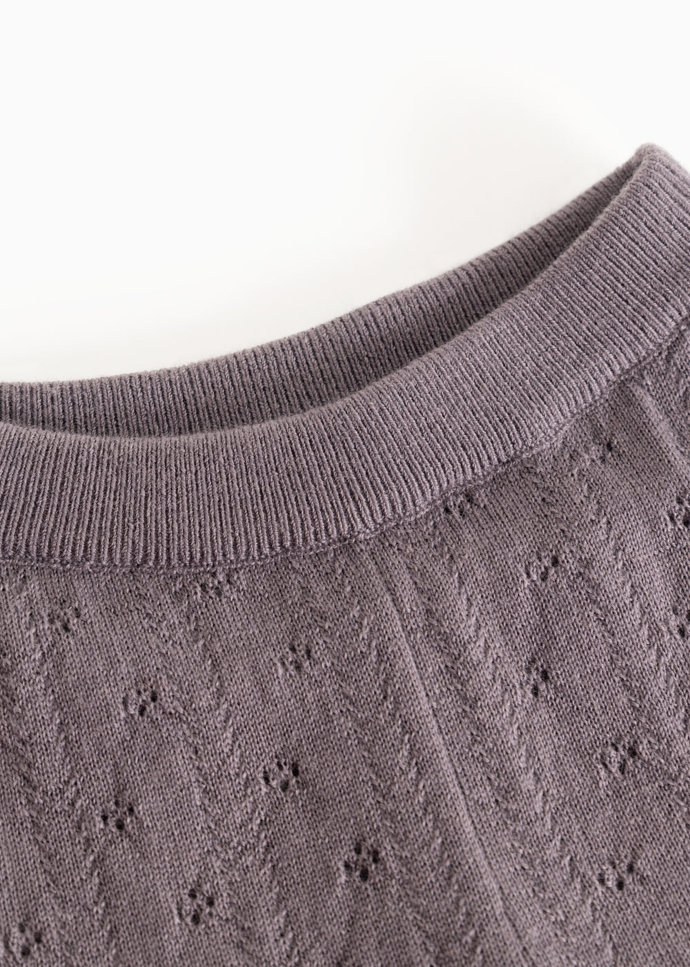 Dark purple knit trousers with ribbed lining and a delicate polka dot pattern.
