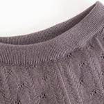 Dark purple knit trousers with ribbed lining and a delicate polka dot pattern.