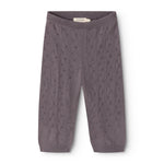 Dark purple knit trousers with elastic waistband and repeated polka‑dot/embossed pattern.