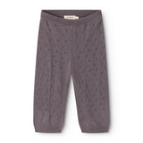 Dark purple knit trousers with elastic waistband and repeated polka‑dot/embossed pattern.