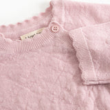 Pink knit cardigan with high collar, button closure, and fine textured pattern.