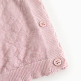 Pink knit cardigan with buttons and ribbed edge at the bottom and sleeves.