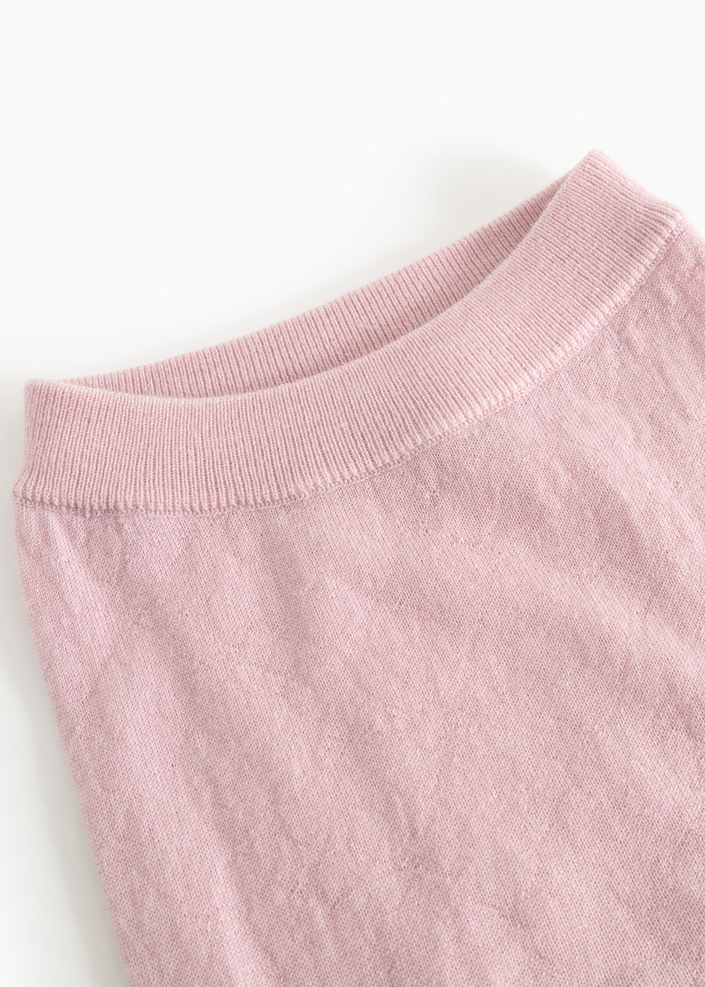 Pink knit trousers with ribbed waist and smooth knit surface.