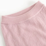 Pink knit trousers with ribbed waist and smooth knit surface.