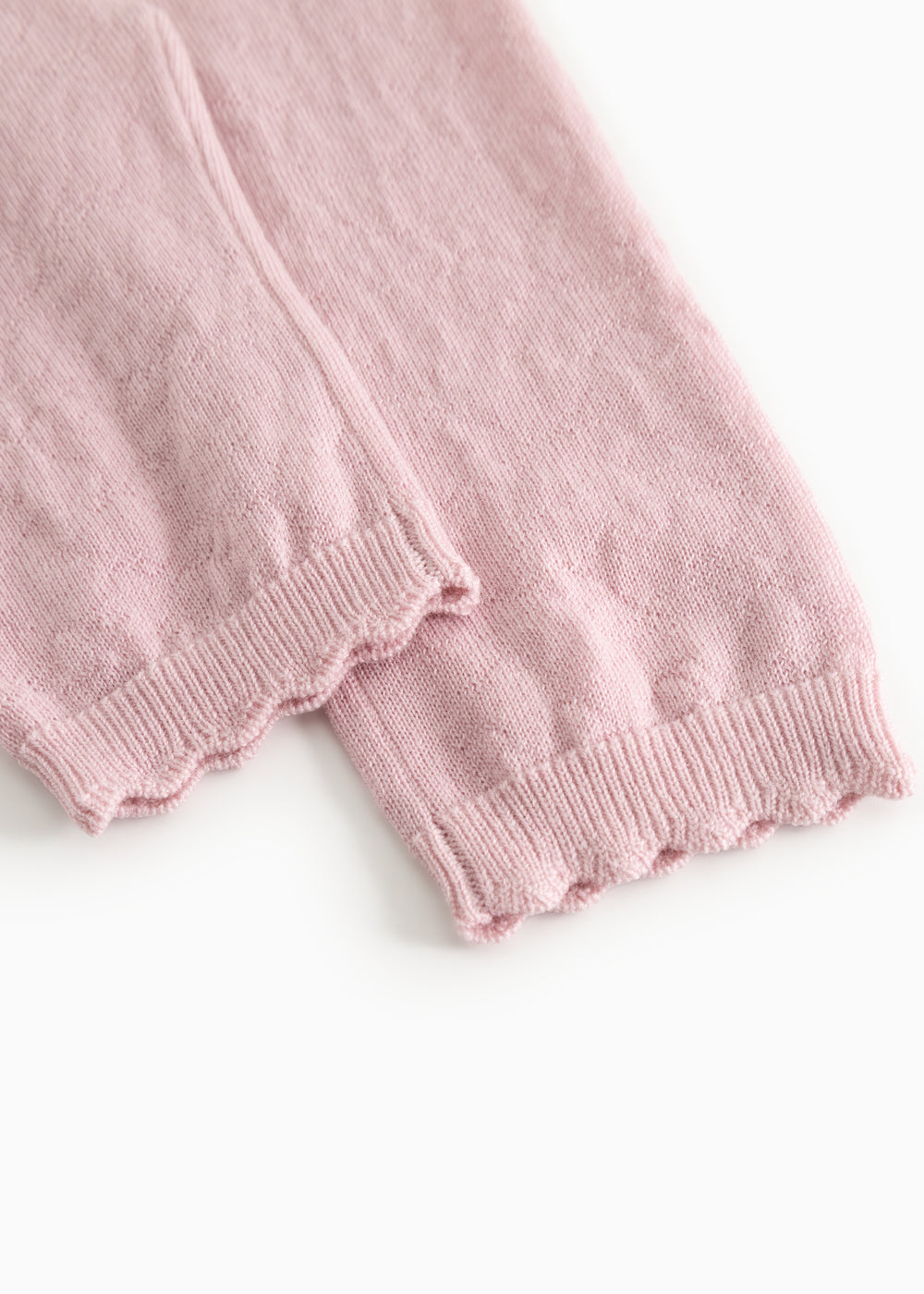 Pink knit trousers with elastic at the hem and visible seam.
