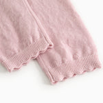 Pink knit trousers with elastic at the hem and visible seam.