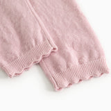 Pink knit trousers with elastic at the hem and visible seam.