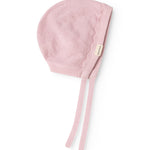Pink knit cap in knit with ribbed edge and two long drawstrings.