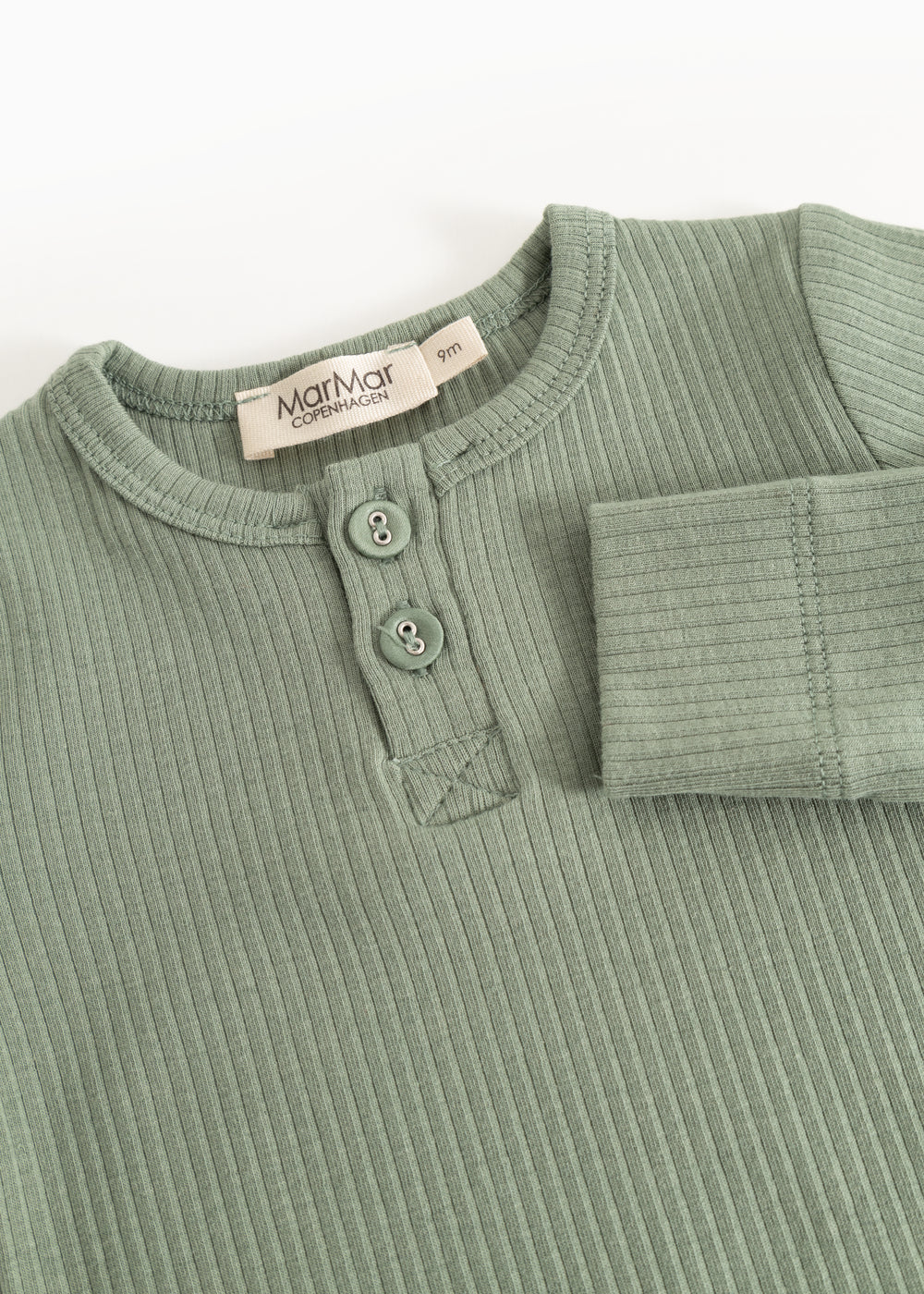 Long-sleeved bodysuit in frost green ribbed fabric with button placket and round buttons at the neck