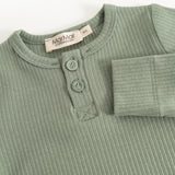 Long-sleeved bodysuit in frost green ribbed fabric with button placket and round buttons at the neck