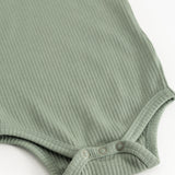 Long-sleeved bodysuit in frost green ribbed fabric with snap buttons at the leg opening