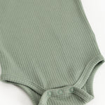 Green ribbed bodystocking with snap buttons at leg opening