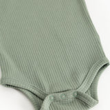 Green ribbed bodystocking with snap buttons at leg opening