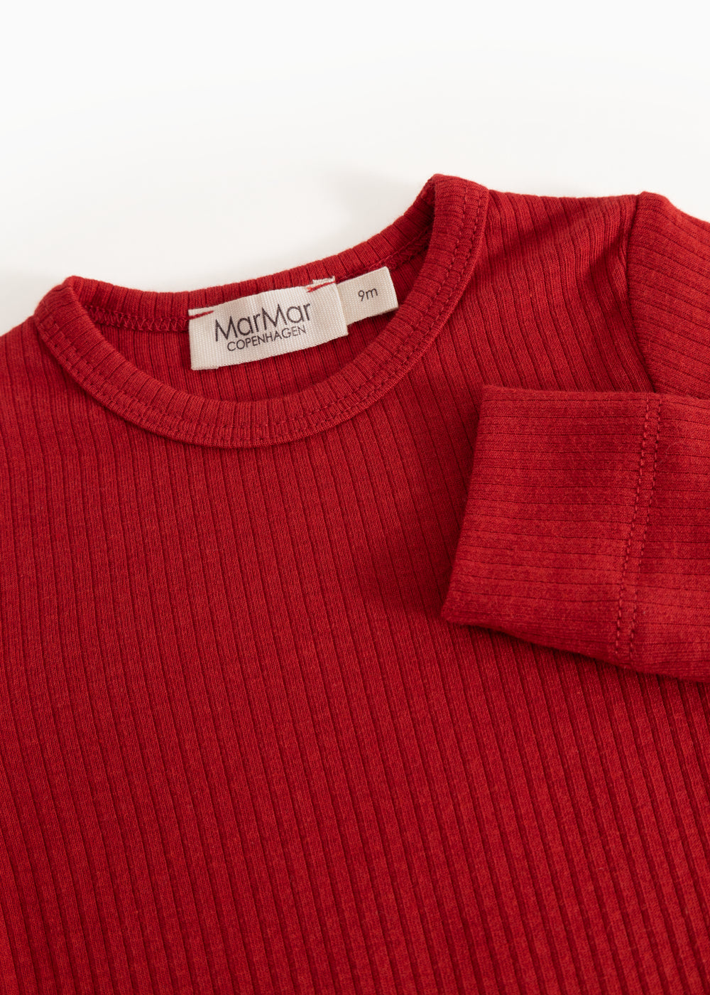 Red long-sleeve bodysuit with ribbed collar and label at neckline