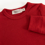 Red long-sleeve bodysuit with ribbed collar and label at neckline