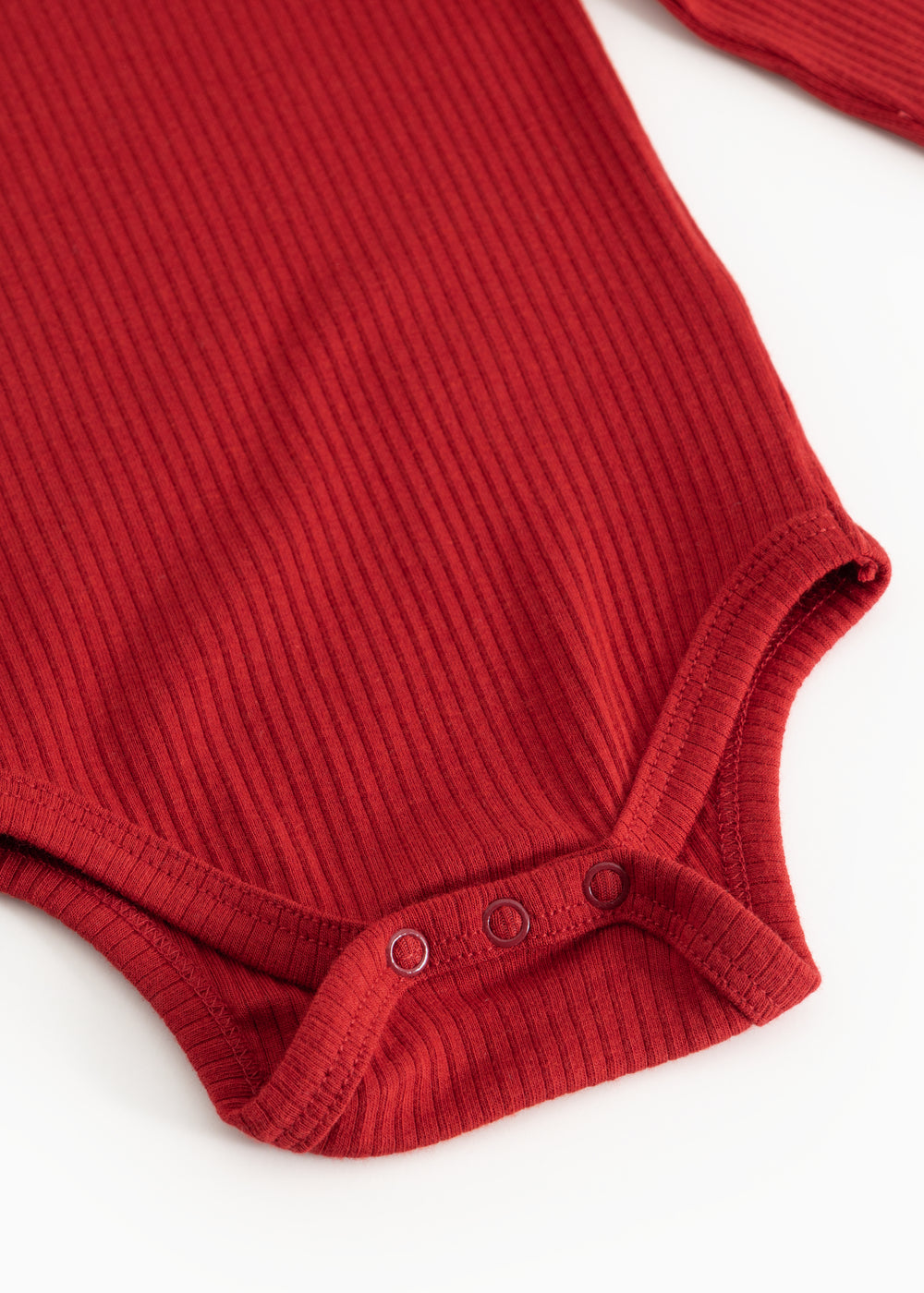 Red ribbed long-sleeve bodysuit with snap buttons at the crotch and hem