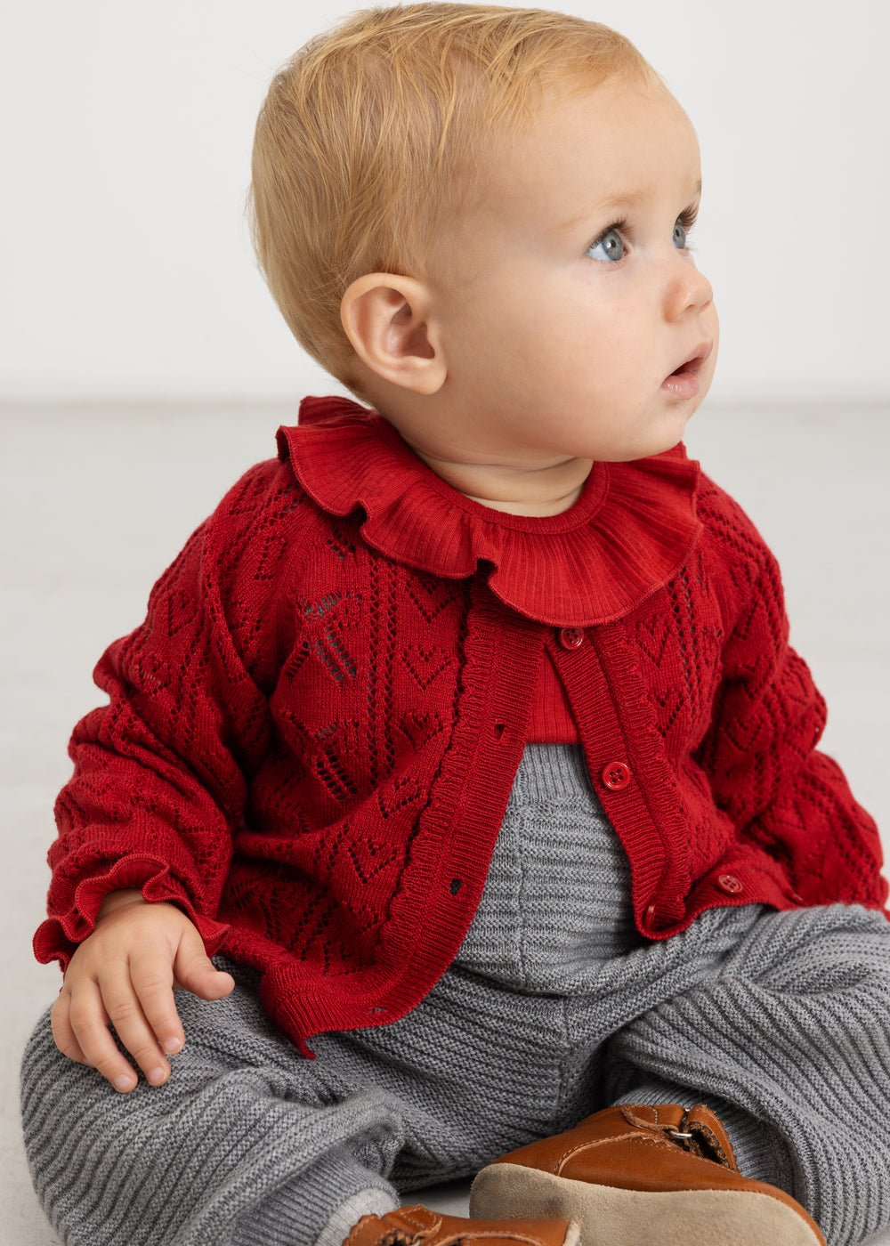 Gray melange knit pants with suspenders and button details at the chest