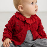 Gray melange knit pants with suspenders and button details at the chest