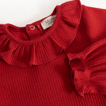 Cherry red ribbed bodystocking with ruffle collar and button closure at the neck.