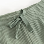 Detail of green waistband on ribbed knit pants with elastic and drawstring