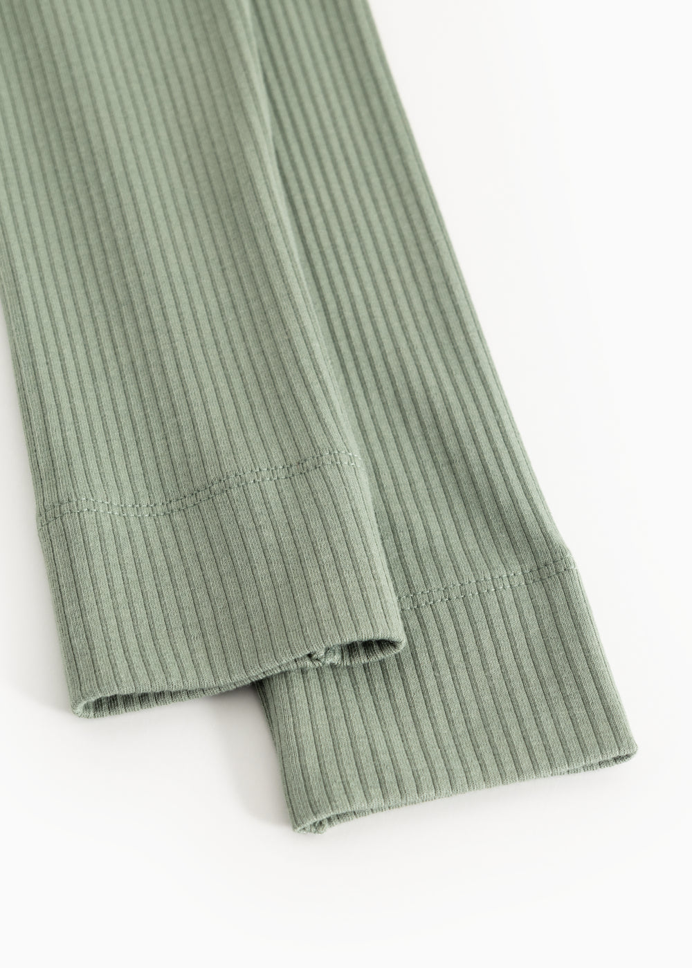 Green ribbed knit leggings with finished hem and visible seam