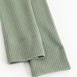 Green ribbed knit leggings with finished hem and visible seam