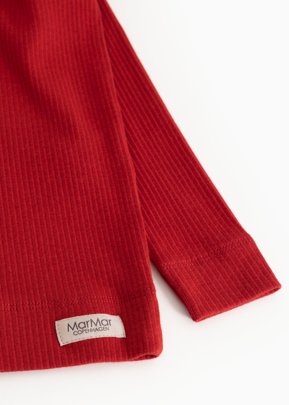 Red long-sleeved T-shirt with ribbed cuffs and label at sleeve end