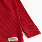 Red long-sleeved T-shirt with ribbed cuffs and label at sleeve end