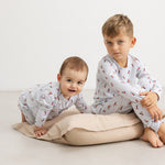 White long-sleeve romper with musician pattern and long legs on two children