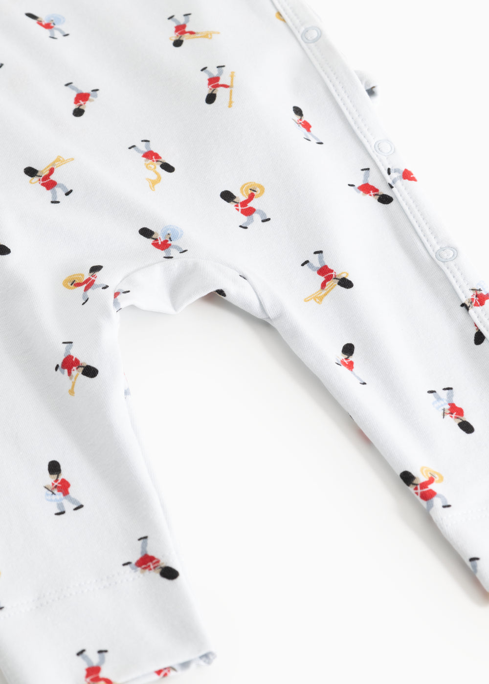 White jumpsuit with musician print and visible seams at leg openings.