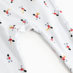 White jumpsuit with musician print and visible seams at leg openings.