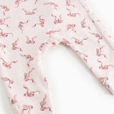 White jumpsuit with red bow print, long legs and leg openings