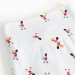 White pants with detailed musician print all over the fabric