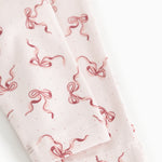 Baby pants with red bow print and visible edge at leg opening