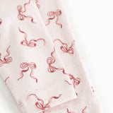 Baby pants with red bow print and visible edge at leg opening