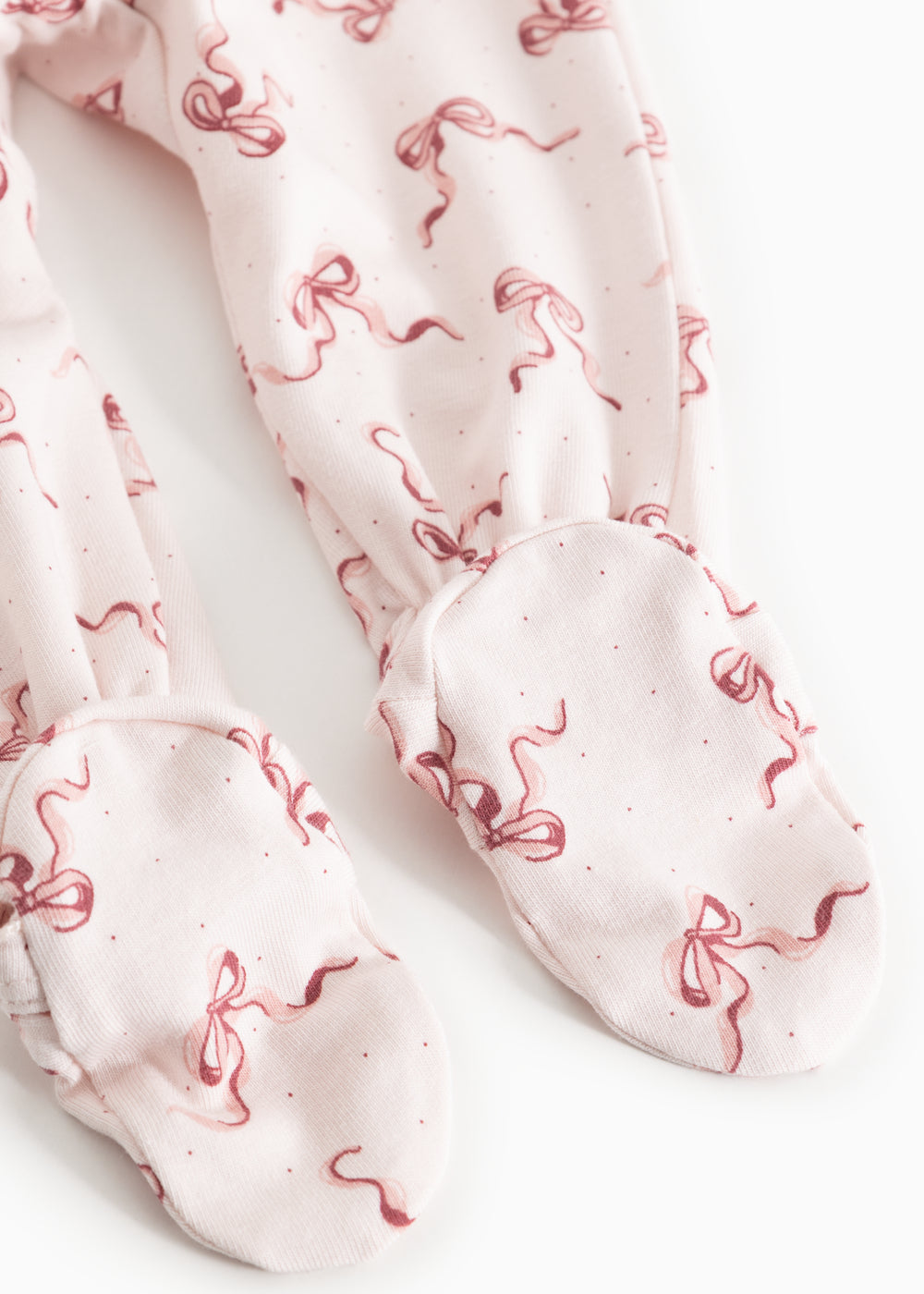 Light baby pants with red bow pattern and folded leg cuffs