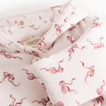 Children's jacket with off-white collar and red bow pattern with button closure