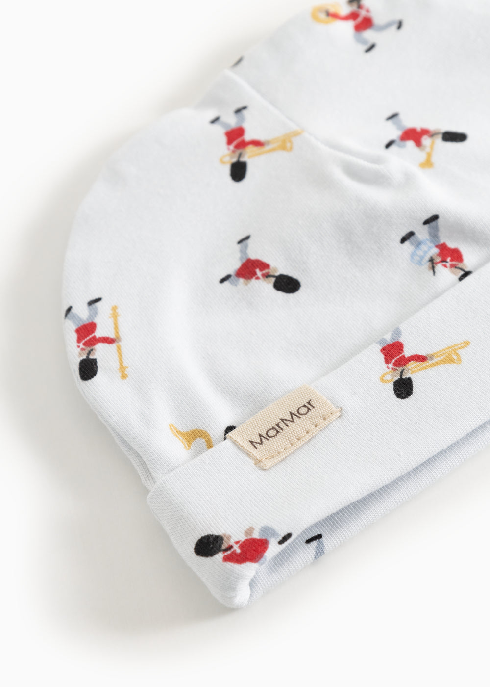 White baby hat with musician pattern and MarMar label