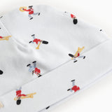 White baby hat with repeated print of musicians all over the hat