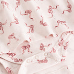 Riva dress fabric with bow print and snap buttons on placket