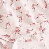 Riva dress fabric with bow print and snap buttons on placket