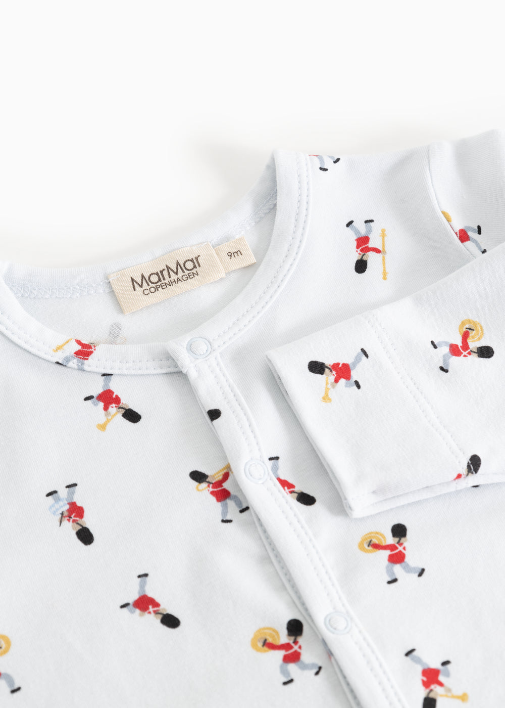 Jumpsuit with round white neckline and musician pattern with visible brand label
