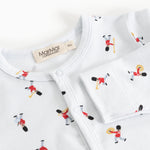 Jumpsuit with round white neckline and musician pattern with visible brand label