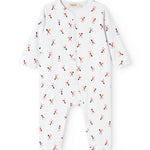 White jumpsuit with long sleeves and legs, round neck, and small musician motifs