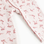 White romper legs with pink bow print and scalloped seam at opening