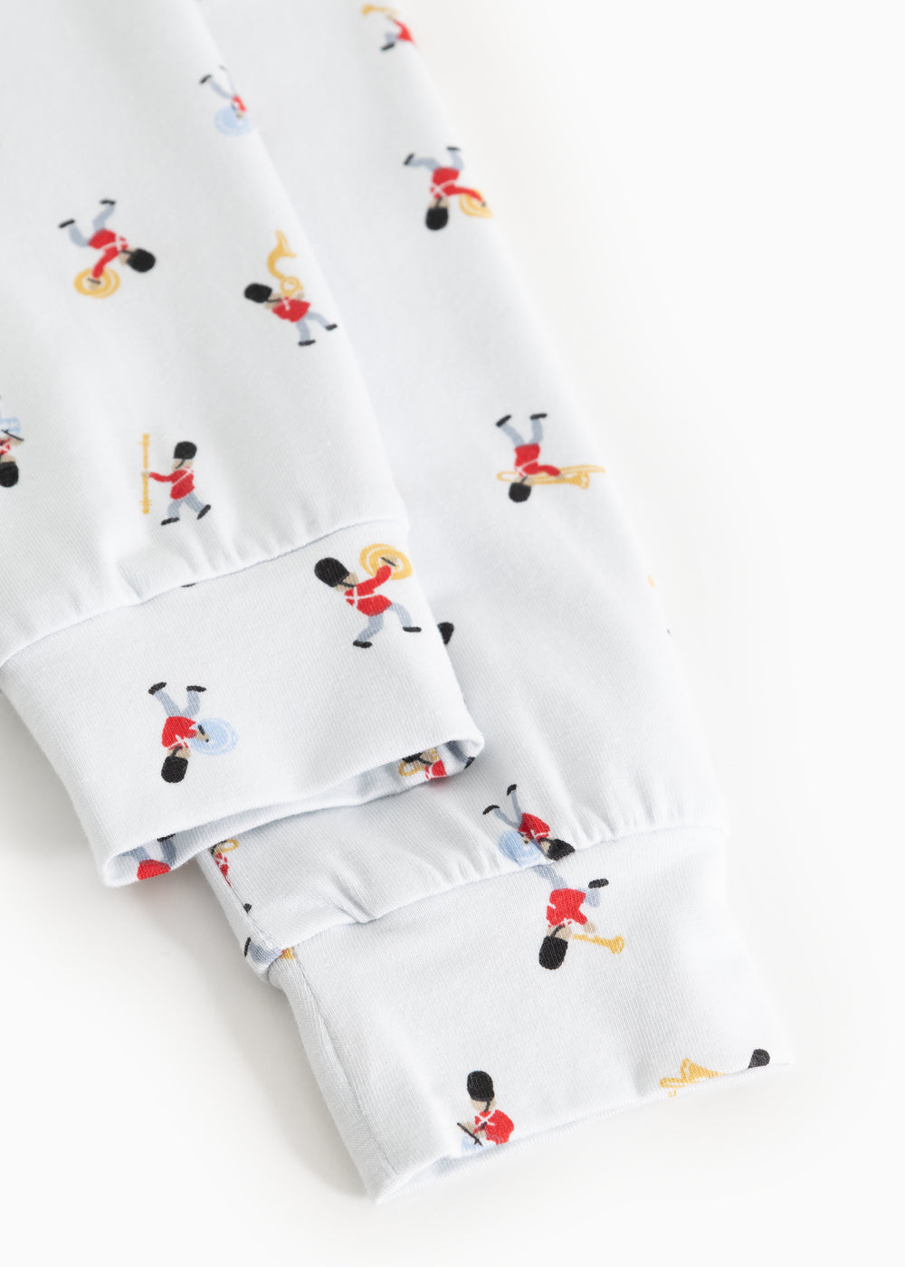 Close-up of cuff and hem on white pajamas with musician print