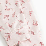 Detail of pink fabric with red bow pattern and gathered edge