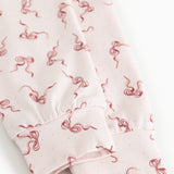 Detail of pink fabric with red bow pattern and gathered edge