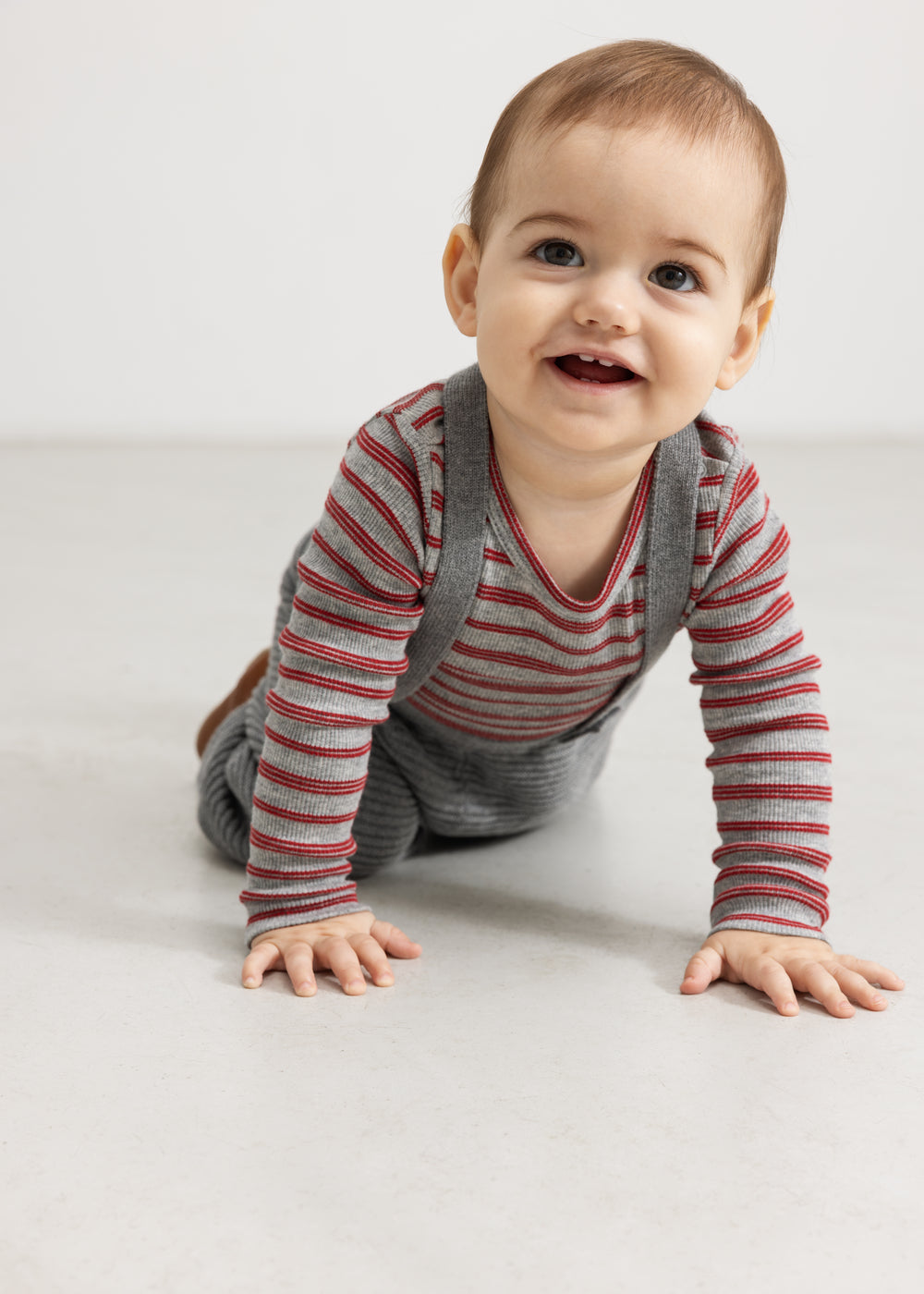 Gray melange knit pants with suspenders, ruched chest piece, and ribbed cuffs at the legs