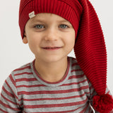 Alfen knitted Santa hat in cherry red with pompom, on a child's head